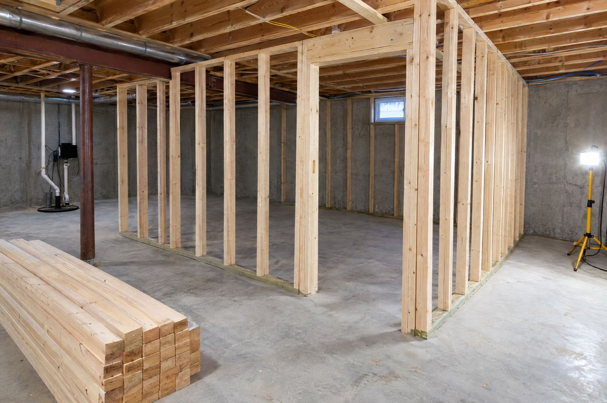 Open wood stud framing in a basement, ready for sheetrock