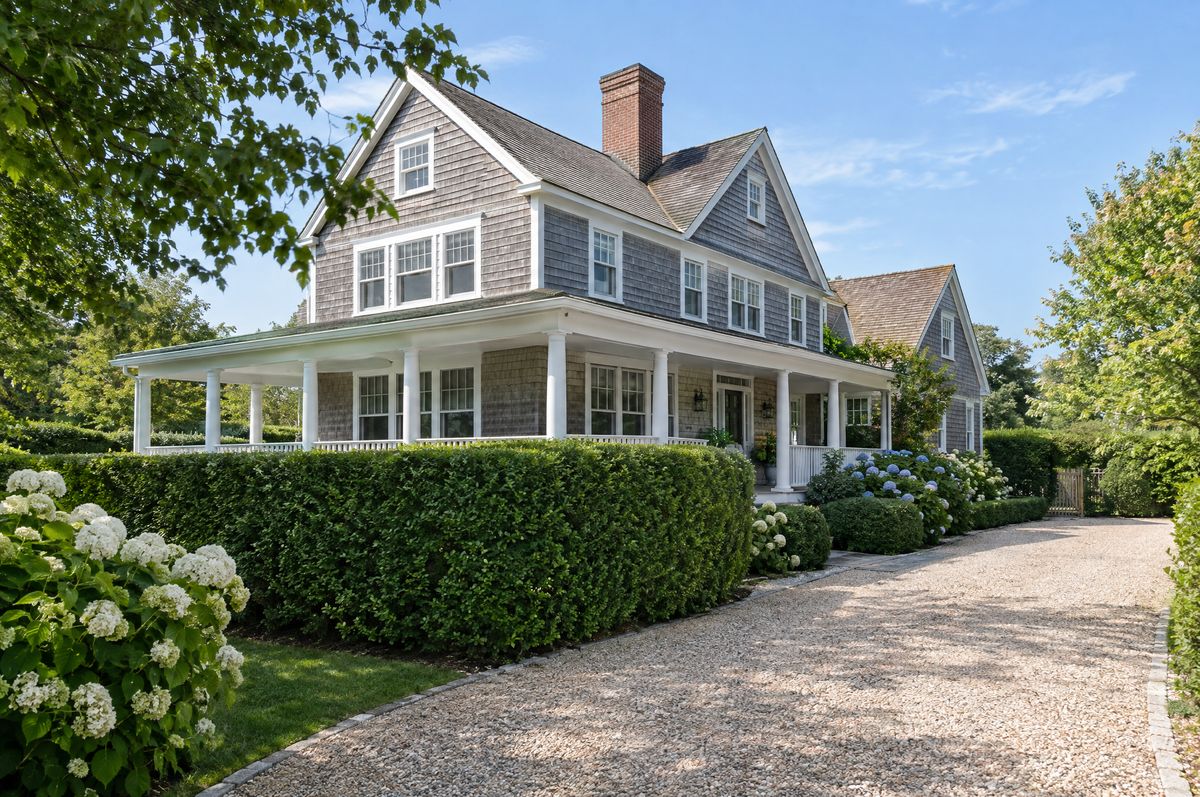 Cedar shingle house with white trim and a green lawn