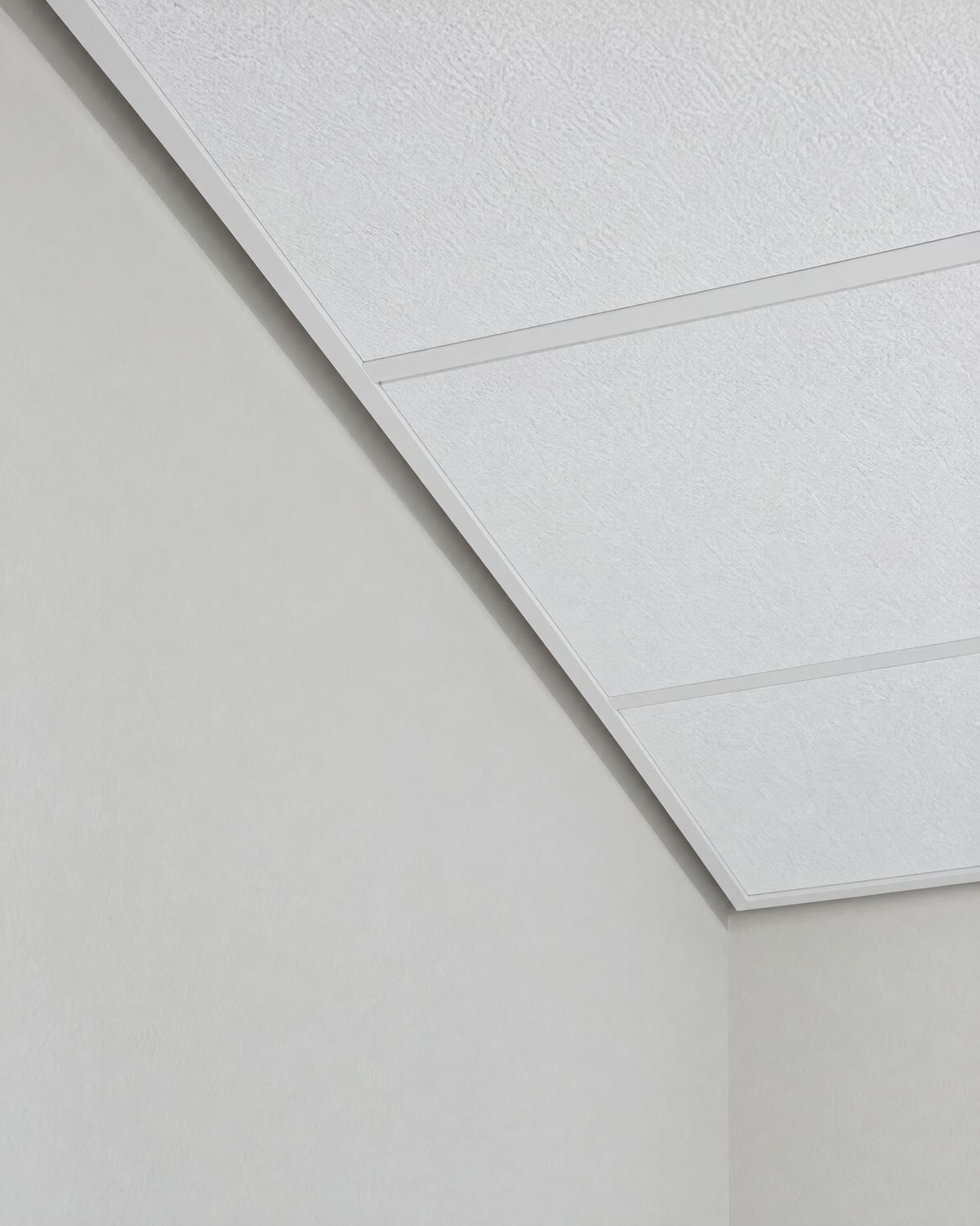 Close-up of recessed reglet trim where a drop ceiling meets a painted wall