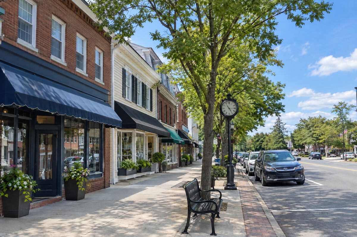 Village main street with shops, street trees and brick sidewalks