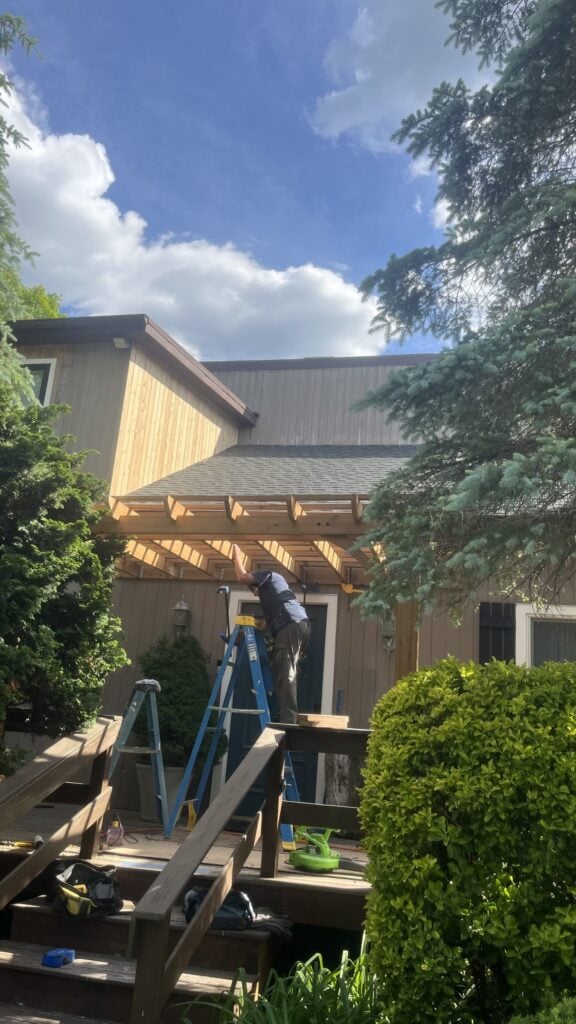 New wood pergola over a backyard deck