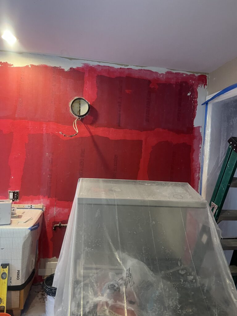 Kitchen walls waterproofed and taped off before new subway tile goes up