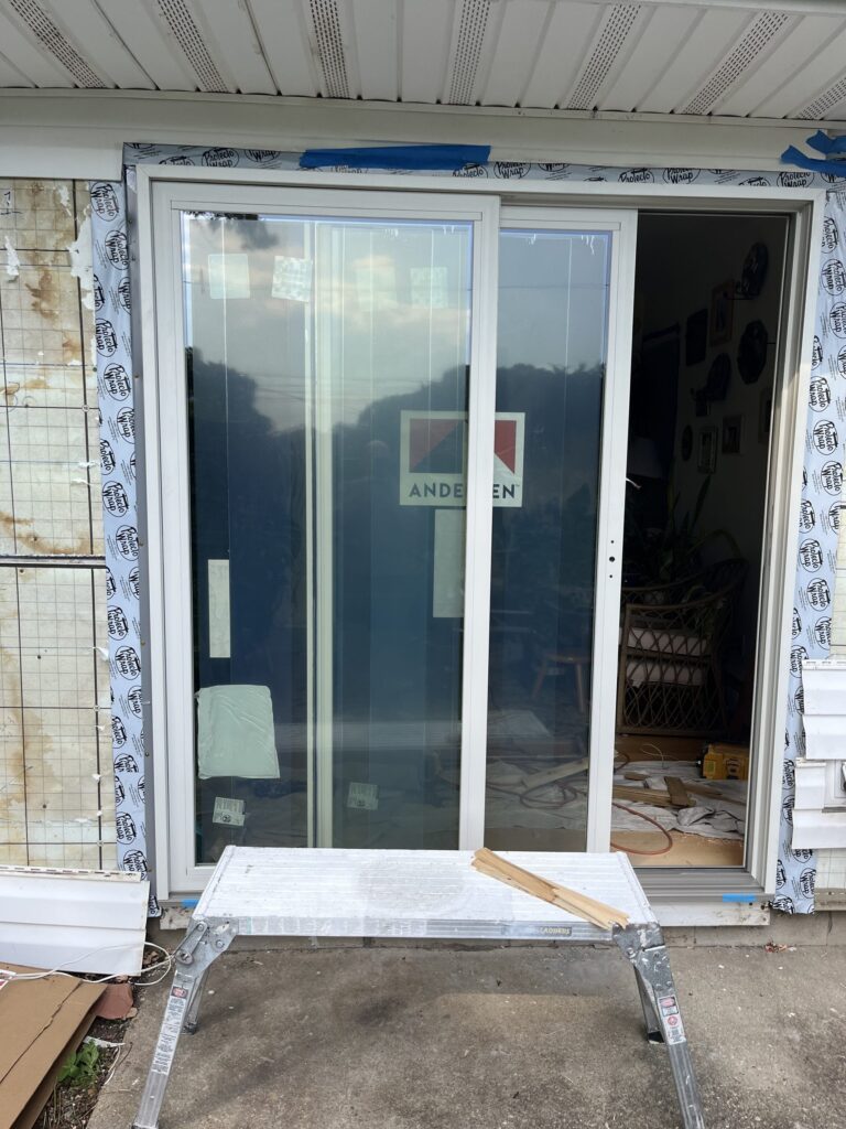 New Andersen sliding patio door set in a wrapped opening, ready for trim